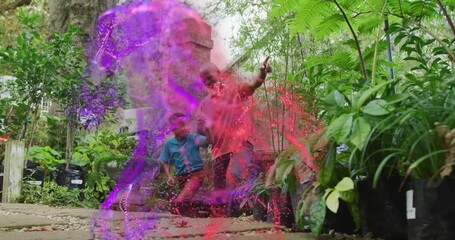 Grandfather pointing upward activating particle swirl enveloping grandson exploring technology - Powered by Adobe
