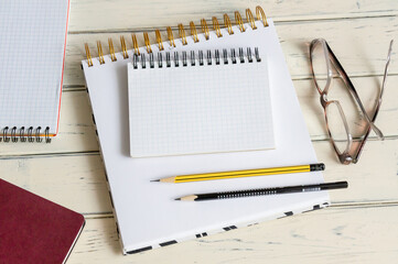 ?pen notepad with blank sheets near glasses and documents. Business and finance concept.