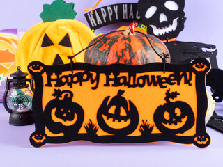 Halloween party ornament with pumpkins and spooky decor on purple