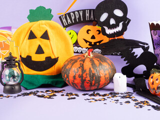 Halloween party ornament with pumpkins and spooky decor on purple