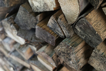 Stack of firewood logs with rough wooden texture. Natural brown tones, close-up view. Rustic background for eco, fuel, or countryside lifestyle concepts. High quality photo