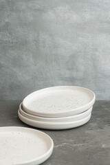 White dinner plates for main courses on a gray background