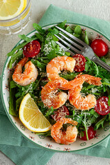 Shrimp salad with arugula and cherry tomatoes, with parmesan cheese, healthy food,