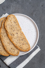 Cheesecakes with different berries on a light plate on a gray table