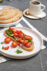 Cheesecakes with different berries on a light plate on a gray table