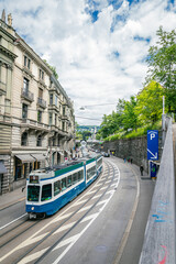 Blue Zurich Tram Turning on a Curve with Historic Buildings
