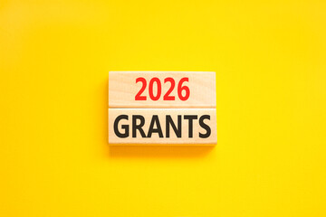 2026 Grants symbol. Concept words 2026 Grants on beautiful wooden blocks. Beautiful yellow paper background. Business and 2026 grants concept. Copy space.