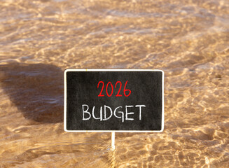 Naklejka premium 2026 Budget symbol. Concept words 2026 Budget on beautiful black blackboard. Beautiful Red sea water background. Business and 2026 budget concept. Copy space.