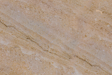 Texture of a natural beige and brown marble surface with diagonal veins and a polished finish. This luxury stone background is ideal for countertops or architectural design.