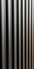Abstract interplay of light and shadow highlighting the texture and depth of metal panels, creating a rhythmic, industrial aesthetic.