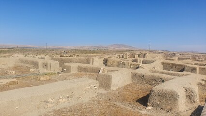 Hasanlu Tepe archaeological mound in West Azerbaijan, Iran — ancient citadel ruins, mud-brick walls, and excavated terraces under blue sky  a timeless Persian heritage landscape and archaeology concep © Mehr