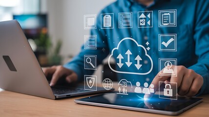 Man working on a laptop and tablet with cloud computing data icon representing global data processing