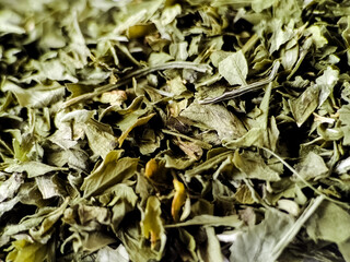 Dried parsley leaves displaying a mix of green and brown hues.