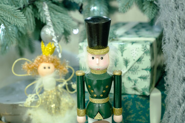 Close-up of a Wooden Nutcracker Figure in Green Uniform and a Fairy Doll. Christmas Decoration