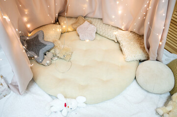 Cozy Children's Reading Nook or Play Area with Fairy Lights, Knit Star Pillows, and White Fur Rug