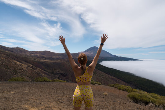 Woman hiking tenerife teide volcano feeling freedom