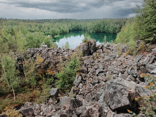 A rocky hillside with a lake in the distance