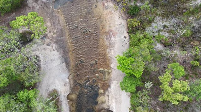 aerial drone shot of a beautiful rainforest landscape along the old telegraph track at the iconic Bertie Creek river crossing in tropical north Queensland of Cape York, Australia.