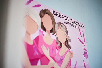 Illustration showing three women including senior, young and middle aged woman standing together wearing pink ribbons promoting breast cancer awareness campaign
