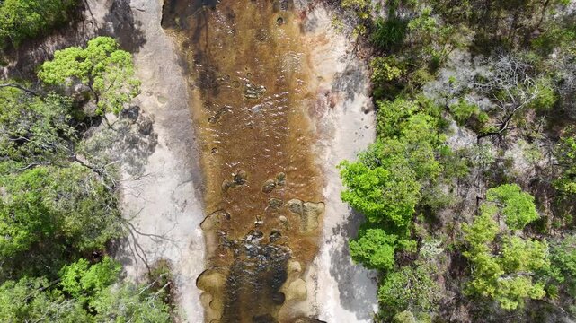 aerial drone shot of a beautiful rainforest landscape along the old telegraph track at the iconic Bertie Creek river crossing in tropical north Queensland of Cape York, Australia.