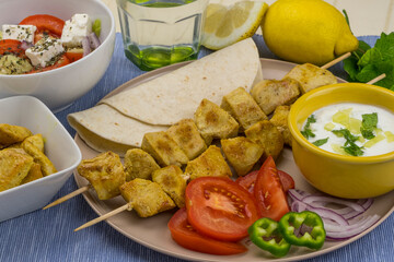 Souvlaki de pollo con ensalada griega y salsa tzatziki