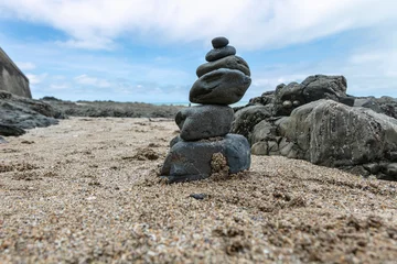 Fotobehang Zen Stenen stones on the beach stacked one on top of the other, creating a stone tower  © marcinmaslowski