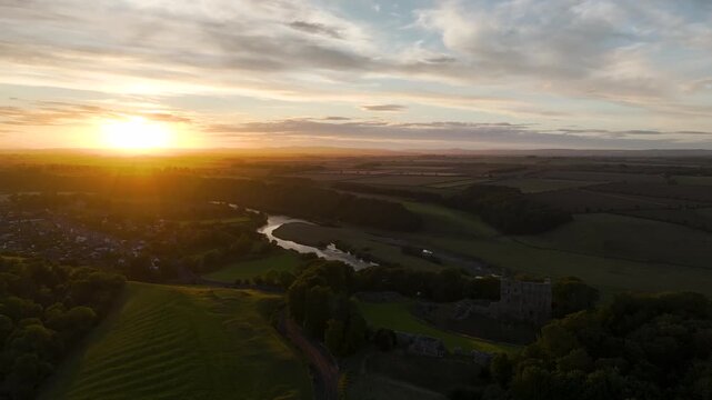 Sunset over Norham Castle and River Tweed from a drone, Norham, Northumberland, England