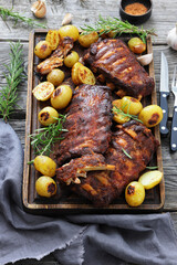 bbq baby pork ribs with potatoes, fresh rosemary