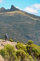 Rear view of a hiker against a mountain background on the Elephant Hill hiking trail in the Aberdare Ranges in Kenya 
