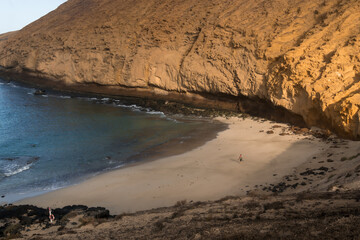 beach with volcanic rock on La Graciosa in the morning