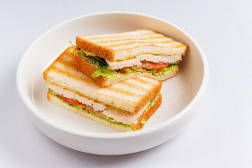 Savory grilled sandwich stacked with turkey, lettuce, and tomato, ideal for a quick meal