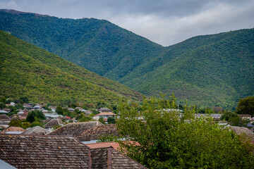 Traditional rooftops and green hills in Shaki, Azerbaijan