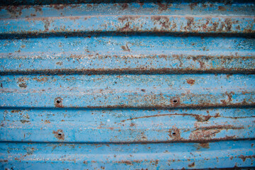 The surface of the metallic blue background. Old metal with worn paint.