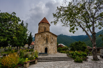 Kish Albanian Church with mountain backdrop in Shaki, Azerbaijan