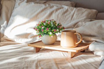 Coffee and Flower Arrangement on Wooden Tray in Cozy Sunlit Interior