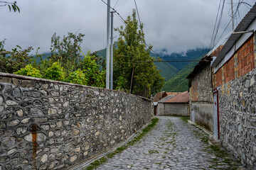 Cobblestone alley with mountain view in Kish village, Shaki, Azerbaijan