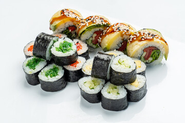 Colorful sushi rolls are arranged beautifully on a white plate, ready to be enjoyed