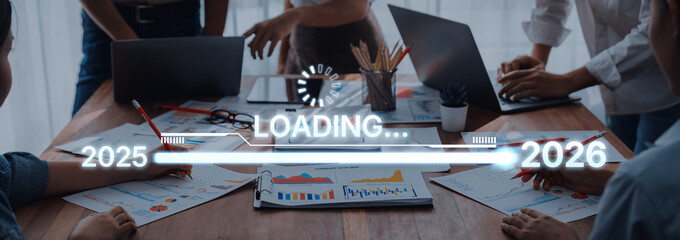 Dynamic business meeting showcasing teamwork with charts and graphs, focusing on strategic planning for the years 2025 to 2026. Ideal for corporate themes. Trope