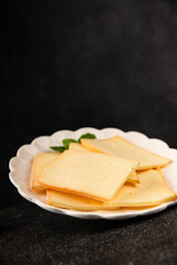 Raclette cheese portion slicing natural product tasty snack fresh delicious gourmet food background on the table rustic top view copy space