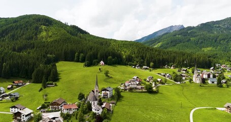 "Kalvarienbergkirche" at "Gosau" Austria old pink church on a hill with mountains in the back