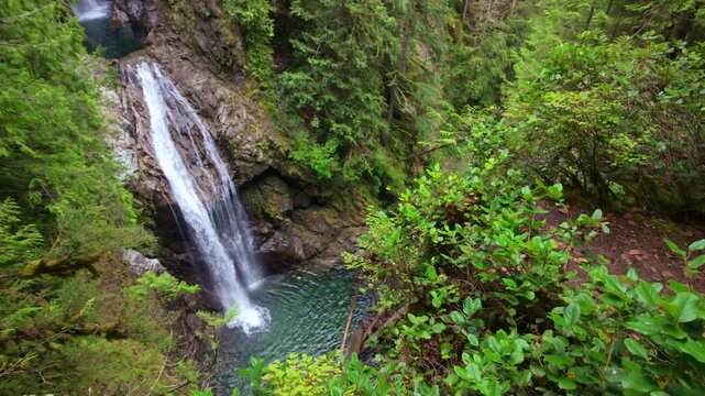 Upper Wallace Falls plunges through a vibrant, moss-draped forest, showcasing the pristine natural beauty of Wallace Falls State Park
