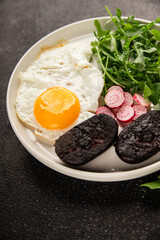 Eggs breakfast black pudding, egg, vegetables, arugula portion size natural product tasty snack fresh delicious gourmet food background on the table rustic top view copy space