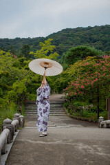 person with a kimono and little umbrella