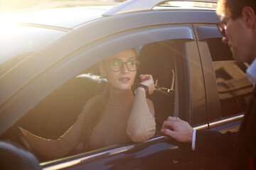 Corporate meeting of two employees in car for work and discussion of business