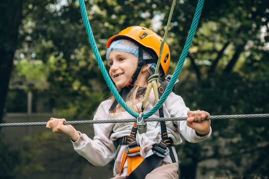 Young Girl Enjoying Adventure Park Rope Course - Powered by Adobe