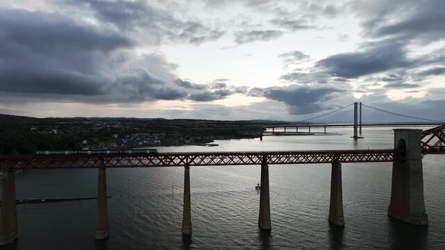 Trains on Forth Bridge from a drone, Queensferry Crossing, Forth Estuary, Scotland