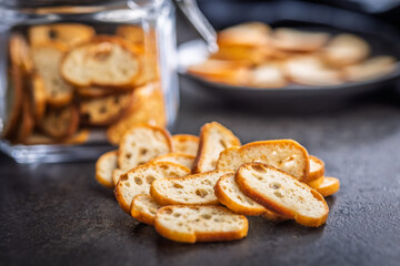 Crispy roasted bruschetta bread on black table.