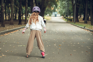 Child Rollerblading in Park with Protective Gear