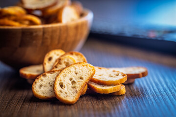 Crispy roasted bruschetta bread on wooden table.