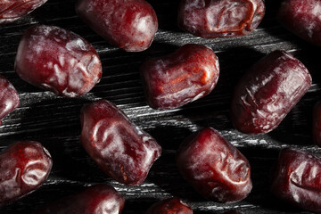 dates fruit on black wood background